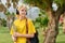 Outdoor portrait of teenage female student in headphones with laptop backpack