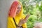 Outdoor portrait of teenage hipster girl with dyed colored hair with smartphone