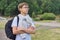 Outdoor portrait of teenager schoolboy with glasses backpack