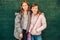 Outdoor portrait of two cute little teen girls wearing warm jackets