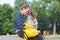 Outdoor portrait of two talking teenagers with smartphone