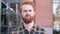 Outdoor Portrait of Upset Redhead Beard Young Man