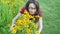 Outdoor portrait of young beautiful fashionable woman smells yellow flowers