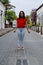 Outdoor portrait of young beautiful girl 19 to 25 years old. Brunette. posing in the middle of a colonial street with cobblestones