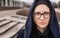 Outdoor portrait of young hipster woman in autumnal cold city park