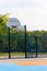 Outdoor public basketball court with synthetic plastic surface.