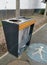 Outdoor public trash sorting bin with pedestrian signage on the ground