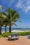 An outdoor rattan sofa on terrace facing the beach