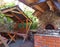 Outdoor recreation area with barbecue, brazier, gazebo, table and bench under a canopy of refractory bricks, natural stone a