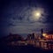 Outdoor restaurant along with mountain cliff in full moon view