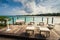 Outdoor restaurant at the beach. Cafe on the beach, ocean and sky. Table setting at tropical beach restaurant. Dominican