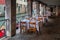 Outdoor restaurant setting with tables with white tablecloth and cutlery