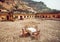 Outdoor restaurant with table under walls of historical fort in Rajasthan. Rural cafe at breakfast time, India