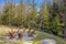 Outdoor rustic firepit surrounded by several chairs in a peaceful setting