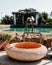 Outdoor scene features a rustic sink situated near a tranquil pool