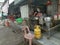 Outdoor scene of a lady preparing take back noodle as the customers waiting at Kg Koh favorite Noodle shop,