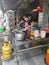 Outdoor scene of a lady preparing take back noodle as the customers waiting at Kg Koh favorite Noodle shop,