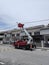 Outdoor scene of workers change streetlight bulb pole with the Rear-mount Ladder truck