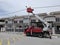 Outdoor scene of workers change streetlight bulb pole with the Rear-mount Ladder truck