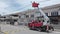 Outdoor scene of workers change streetlight bulb pole with the Rear-mount Ladder truck