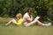 Outdoor school. Father and son reading book in park, man encourages boy to knowledge, family education. Father and child