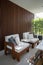 Outdoor seating corner with wood batten background in tree shade  /interior design / outdoor space / copy space