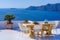 Outdoor seats facing Aegean Sea in Oia, Santorini, Greece