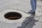 Outdoor sewer and feet in jeans, close-up