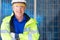 Outdoor shot of Caucasian engineer inspect electrical solar panel wearing hardhat , protective eyeglass and safety equipment with