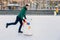 Outdoor shot of happy delightful man with thick beard and mustache looks gladfully into camera, demonstrates going skating on ice