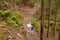 Outdoor shot of wandering explorer travelling with map in forest, going for hiking, spending vacation with pleasure, being
