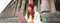 Outdoor shot of young stylish redhead girl sits on staircase and connects to public wifi, uses digital tablet, reads