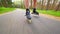 Outdoor shuffle inline skating. Mans legs roller skating on forest asphalt path. Close up view to quick shuffle movement of inline