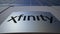 Outdoor signage board with Xfinity logo. Modern office building. Editorial 3D rendering