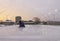 Outdoor skating rink being cleaned for early morning sunrise ska