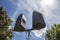 Outdoor speakers over leaf and blue cloudy sky