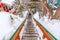 Outdoor stairway with grated metal treads in a snowy mountain town in winter