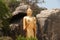 Outdoor Standing golden Buddha at Khao Takiab temple, Hua Hin Beach.