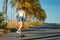 Outdoor summer portrait of cheerful young woman riding longboard in sunny day.