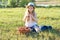 Outdoor summer portrait of little girl with basket strawberries