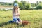 Outdoor summer portrait of little girl with basket strawberries