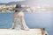 Outdoor summer portrait of young pretty woman looking at the sea in the port of Agios Nikolaos, enjoy her freedom and fresh air, w