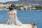 Outdoor summer portrait of young pretty woman looking at the sea in the port of Agios Nikolaos, enjoy her freedom and fresh air, w