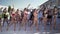 Outdoor summer vacation, crowd of young beautiful girls in bikinis will cheerfully spend their time actively dancing by