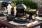 outdoor table with ceramic dishes and food next to barbecue backyard grill