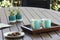 Outdoor table setting with cookies, two turquoise coffee cups, book, flowers