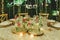 Outdoor tables for an elegantly decorated wedding reception, with lovely floral centerpieces and vintage style tableware and