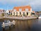 Outdoor terrace of cafe and canal in old town of Workum in Friesland, Netherlands