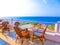 Outdoor terrace of restaurant overlooking the sea and palm trees