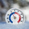 Outdoor thermometer in snow shows sub-zero temperature cold winter weather concept